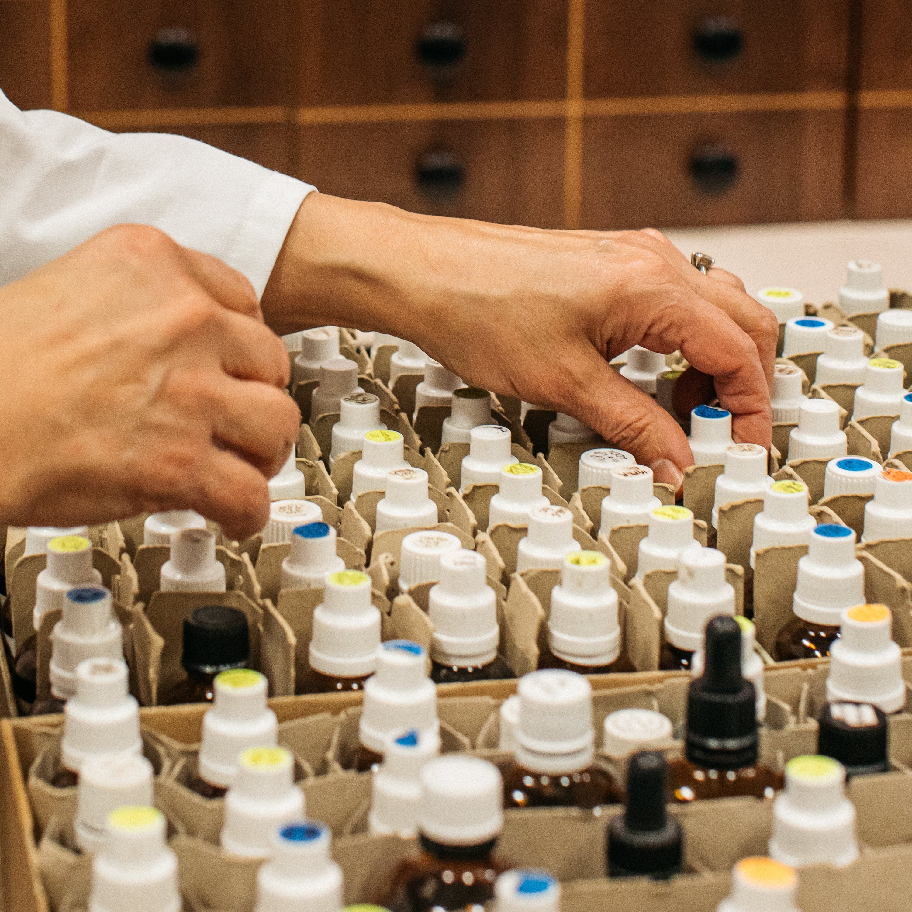 Homeopathic Pharmacist restocking bottles in Mayfair, London Pharmacy