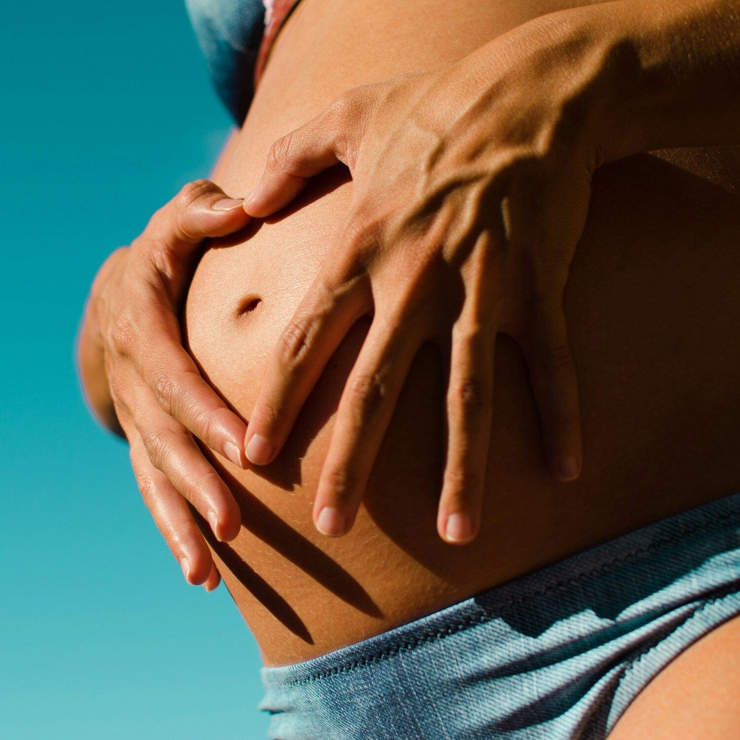 Pregnant woman holding bump