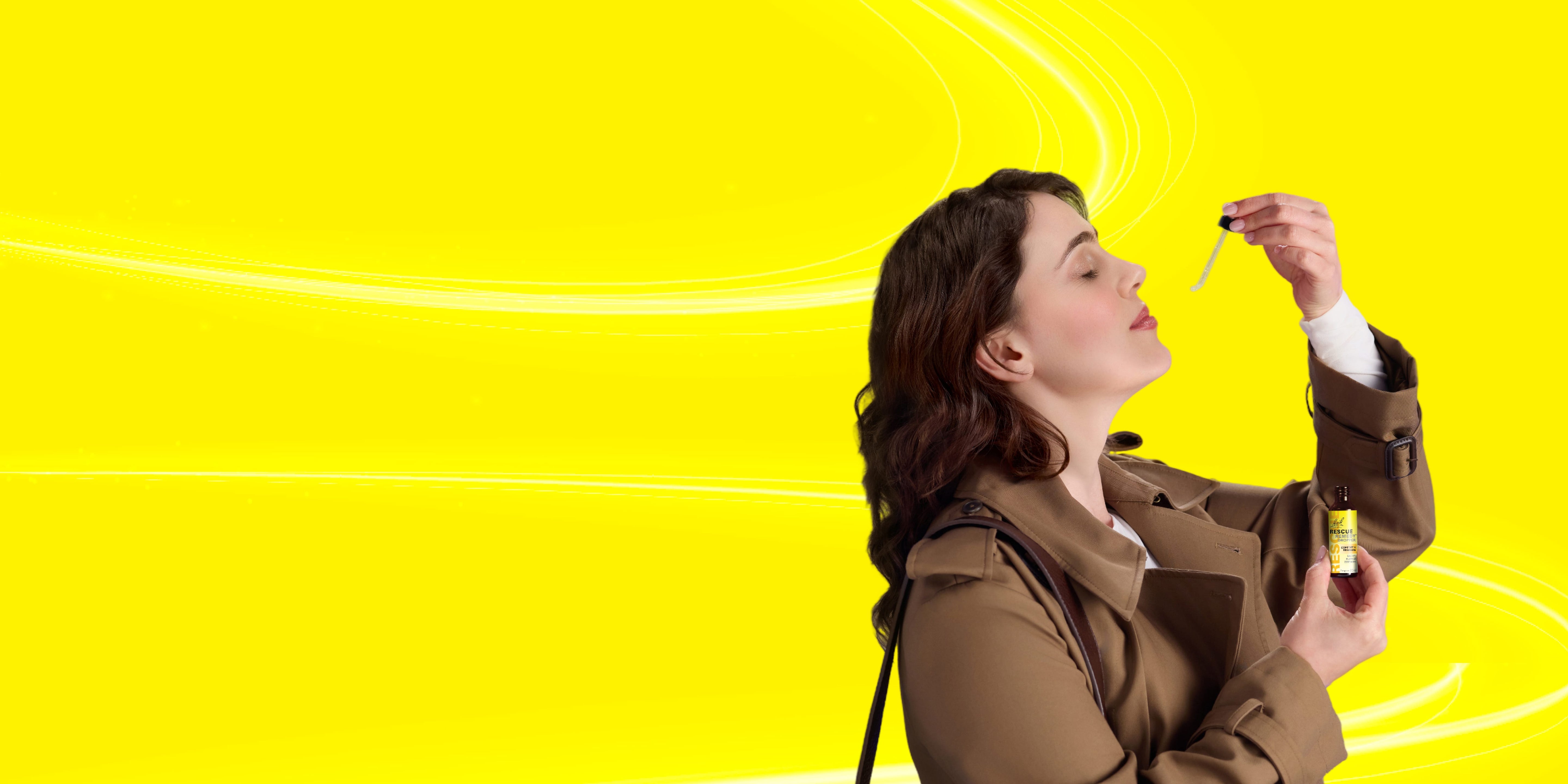 Woman holding a dropper with a yellow background