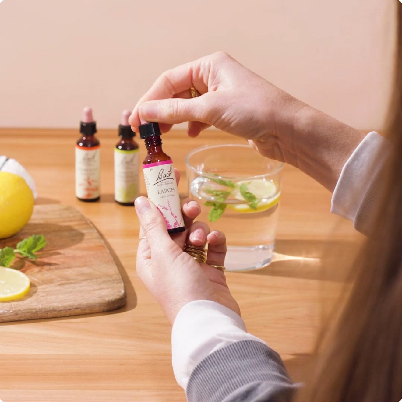 Bach™ Original Flower Remedy Larch Dropper into a glass of water in kitchen