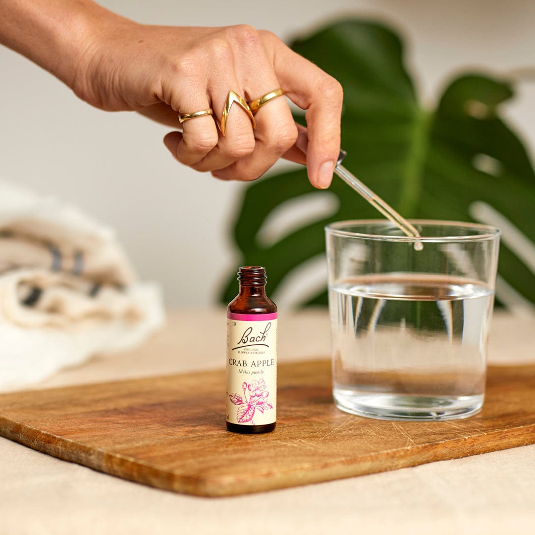 Hand dropping Bach™ Original Flower Remedy Crab Apple into water