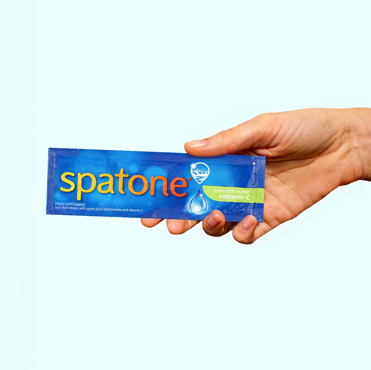 Spatone® Apple with vitamin C sachet in hand