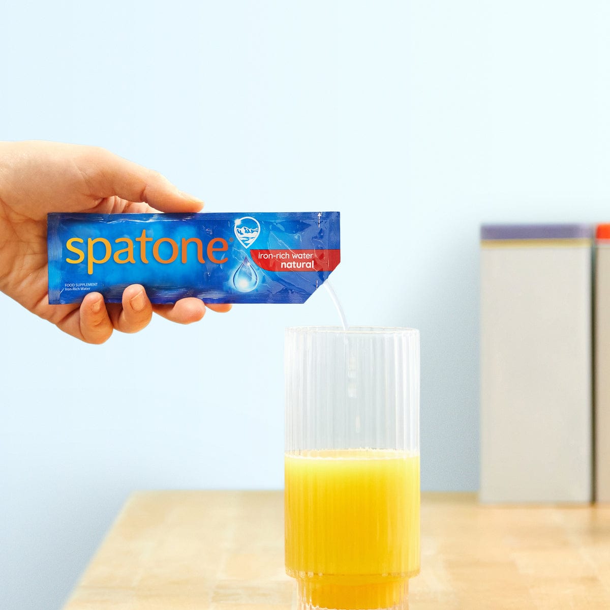 Spatone® Original sachet poured into a glass of orange juice