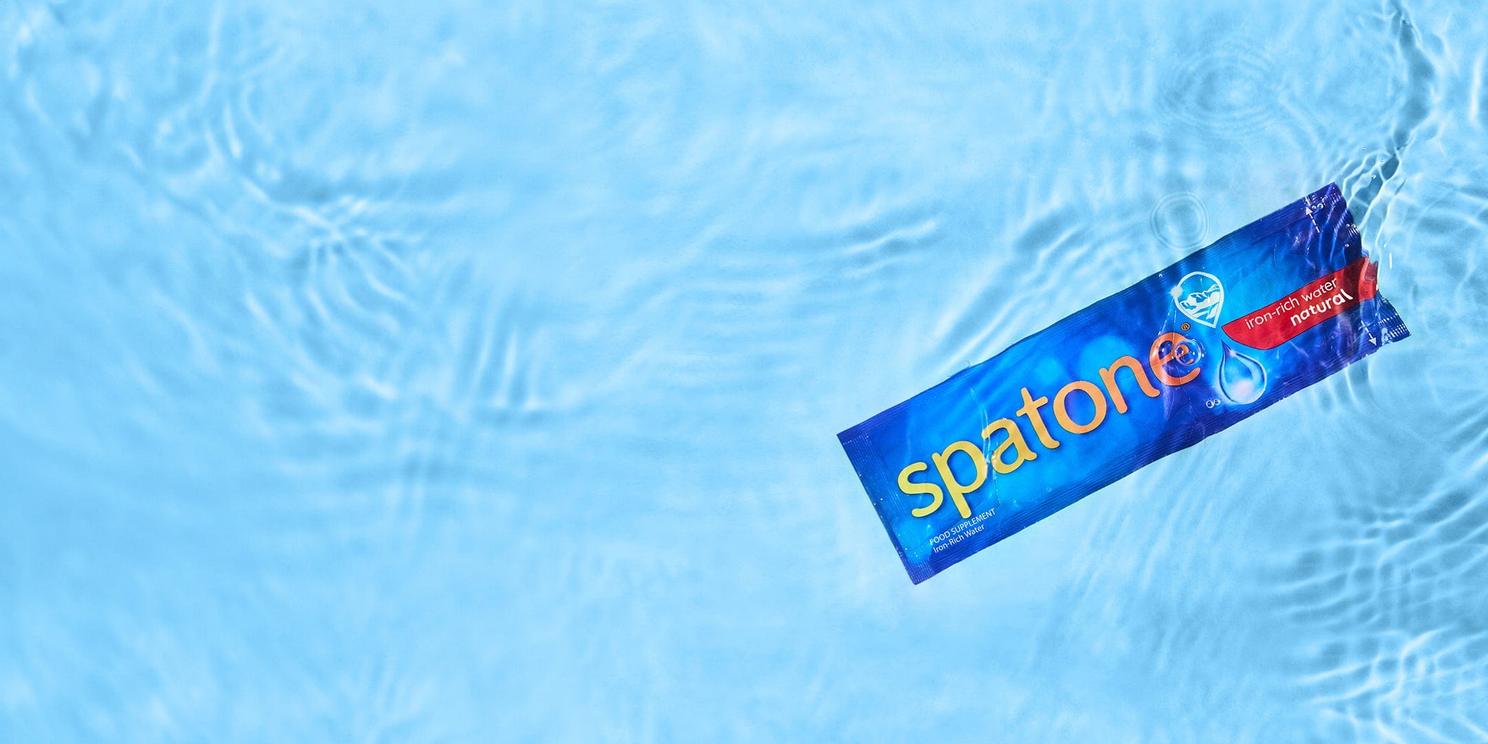 Spatone® iron-rich water food supplement floating in a pool