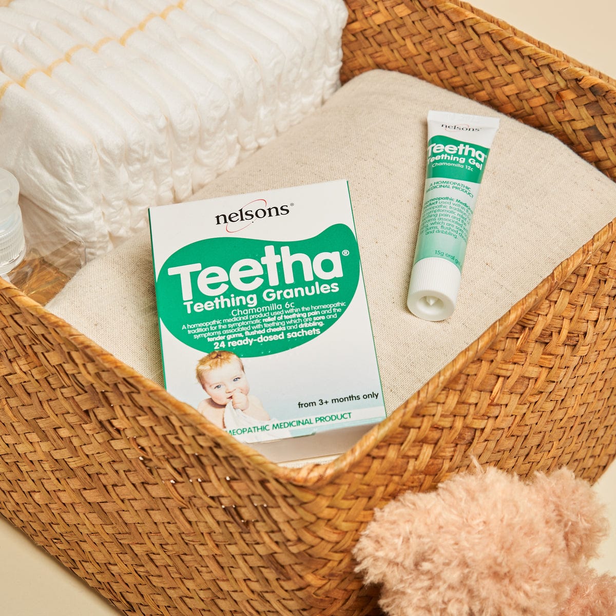 Nelsons Teetha® Granules teething homeopathic remedy 24 read-dosed sachets pack and Teething Gel in baby changing basket with teddy bear
