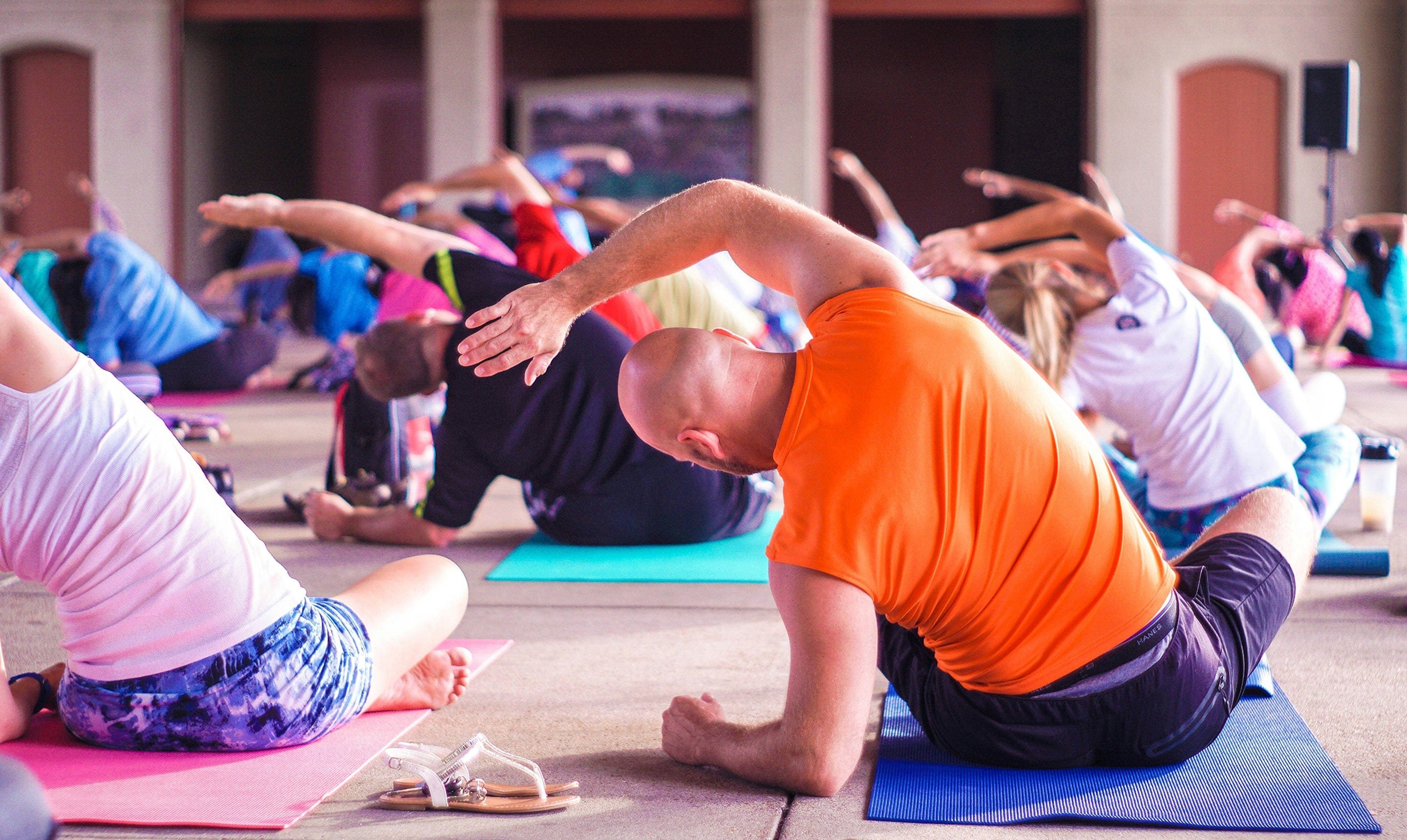 Men and women of different generations exercising, doing yoga and stretching