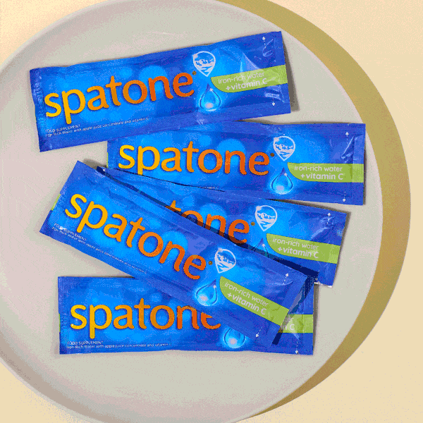 Spatone® Apple iron-rich water with vitamin C on a plate moving