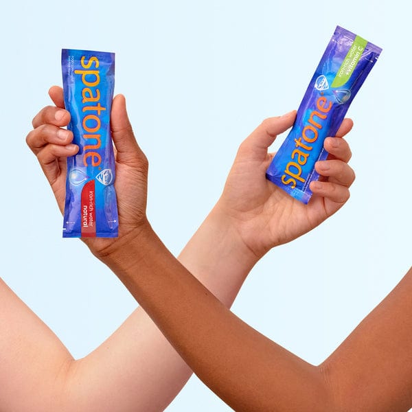 Spatone® Original Sachet and Spatone ®Apple with Vitamin C Sachet in hands